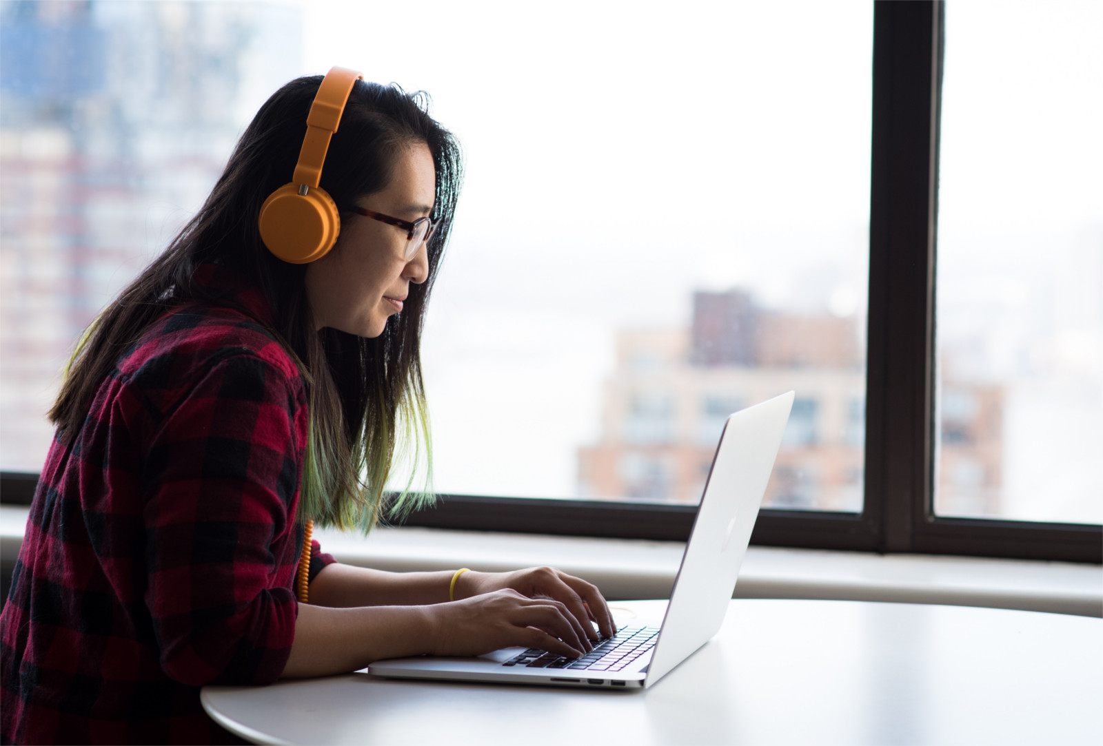 woman one laptop with headphones